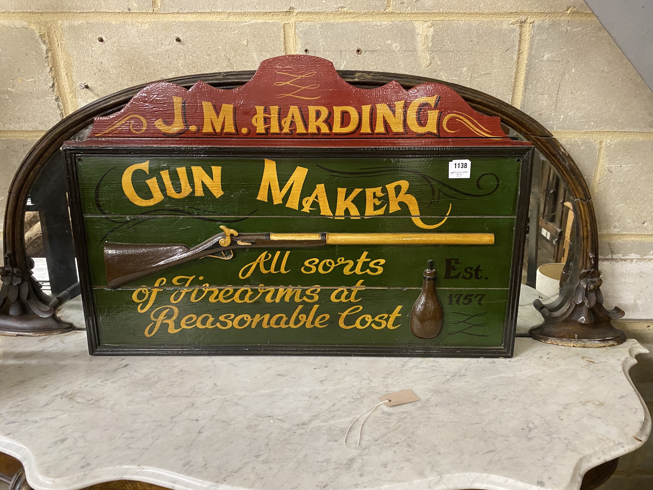 A reproduction painted wood 'Gunmaker' sign, width 90cm, height 61cm